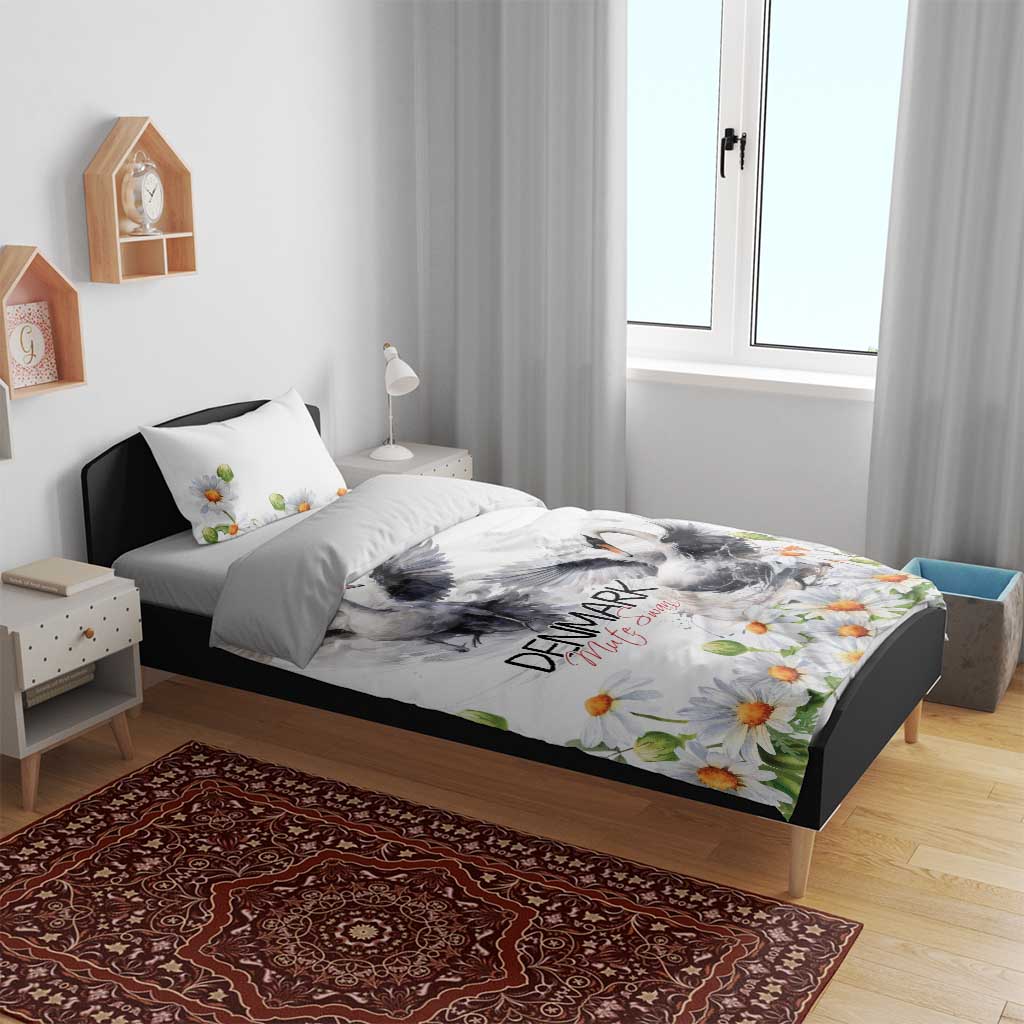 Swan and daisy bedding set with white duvet and pillowcases on a low bed