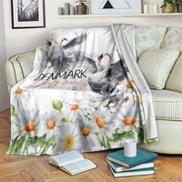White swan and daisy throw blanket draped over a sofa