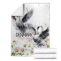White throw blanket with gray swans and chamomile daisy border, folded neatly