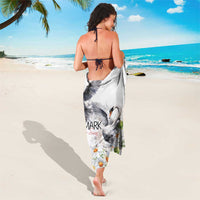 White sarong worn like a wrap, swan illustration with daisy print and 'Denmark'