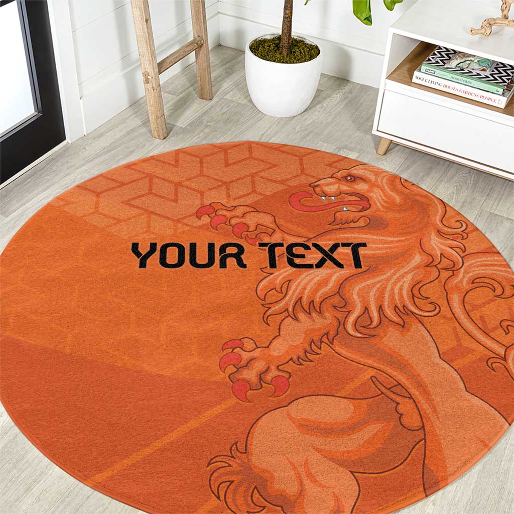 Orange round football carpet with custom 'YOUR TEXT' and roaring lion emblem