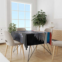 Black tablecloth with double-headed eagle and crest, draped over dining table