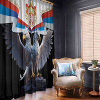 Black window curtain with Serbian eagle banner print, draped beside chair