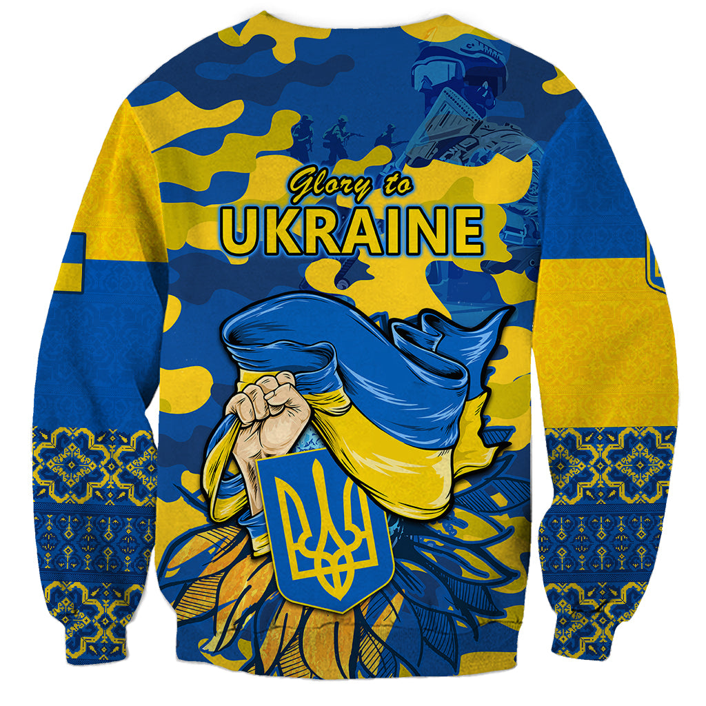 Unisex blue and yellow sweatshirt with camo background and Glory to Ukraine back graphic