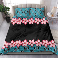 Black duvet and pillow with turquoise geometric border and pink hibiscus floral print