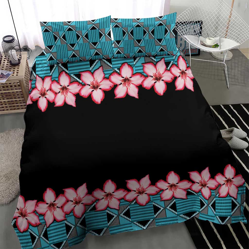Black duvet top with pink hibiscus garland and turquoise geometric stripe hem