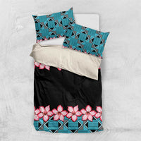 Folded bedding set: black base with turquoise geometric pattern and pink hibiscus flowers