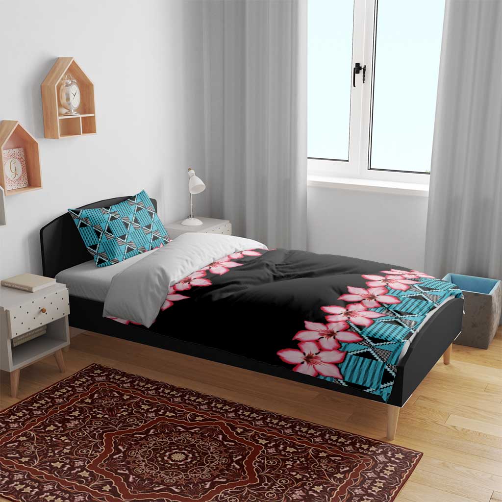 Black bedding set with turquoise geometric pillow panels and pink hibiscus flower accents
