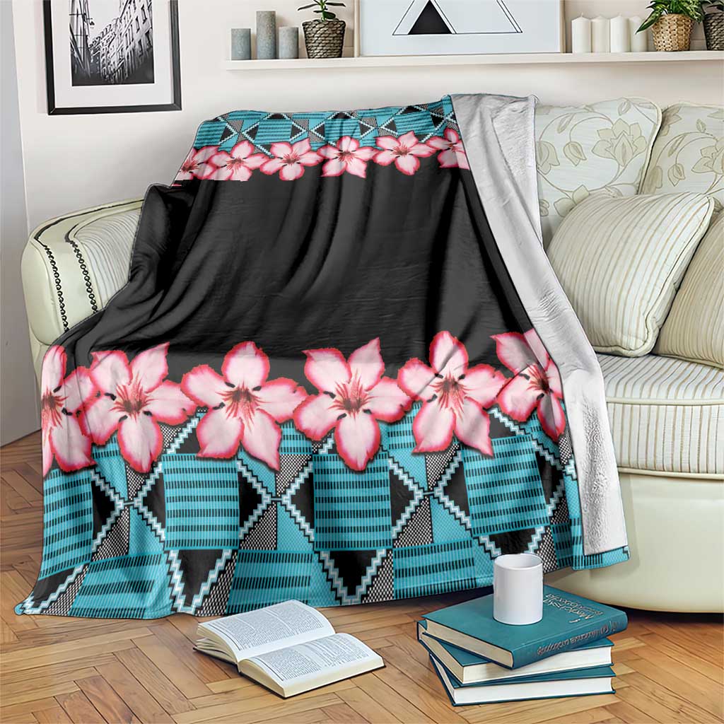 Black throw blanket with pink blossoms and blue geometric trim