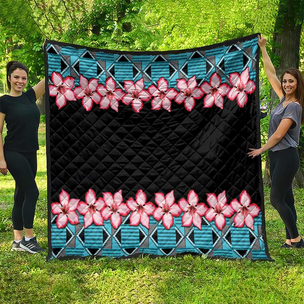 Black quilt with teal geometric edging and pink white flowers, large quilted blanket