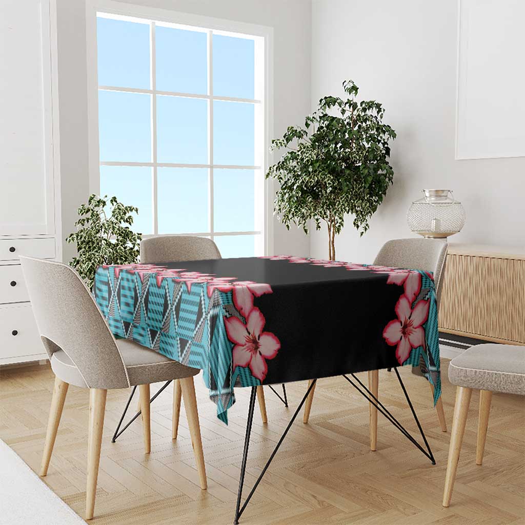 Tablecloth with black fabric, red hibiscus flowers, and blue geometric pattern