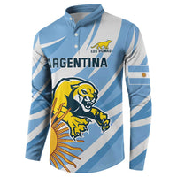 Light blue rugby button sweatshirt with white diagonal stripes and Los Pumas logo