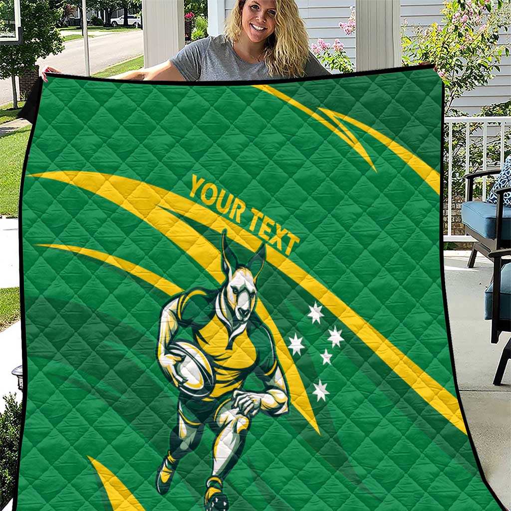 Green quilt wall hanging with Wallabies mascot, yellow swoosh, and 'YOUR TEXT'.