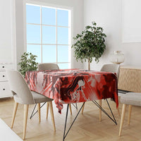 Red horse race tablecloth draped on dining table with chairs