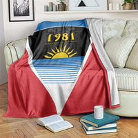 Flag blanket with red and blue panels, white triangle, and 1981 sun emblem
