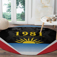 Round carpet with black center showing '1981' and yellow sun, blue stripes, red border