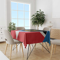 Red tablecloth with black center panel, white V, blue stripe, and yellow sun on table