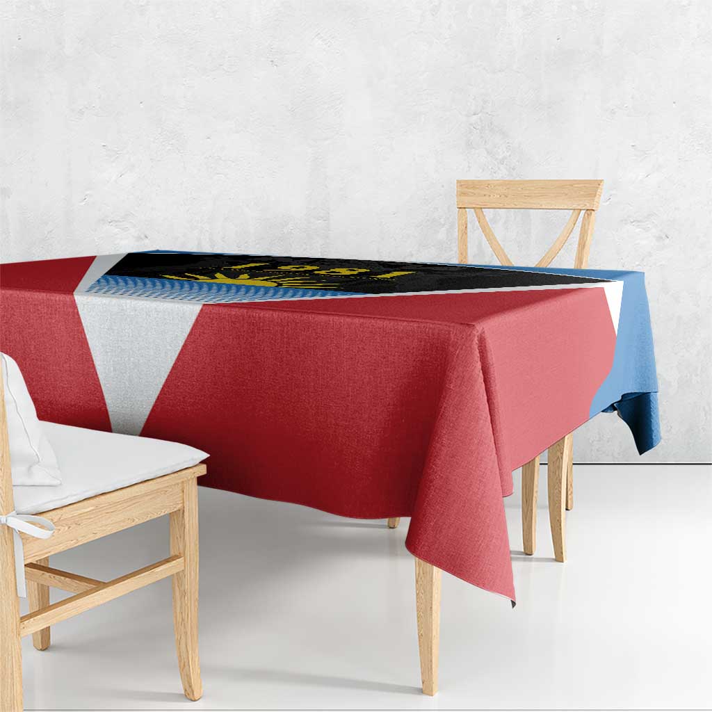 Red tablecloth with black-and-blue print and white V, hanging over table edge