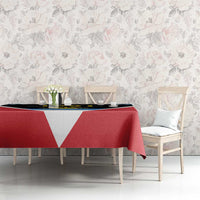 Red tablecloth with white V and blue stripe on rectangular table in room setting
