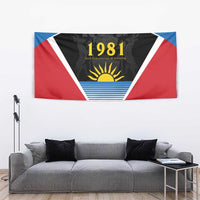 Gray sofa backdrop with Antigua 1981 tapestry flag showing triangular sun and stripes