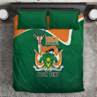 Green bedding set on rug, 1958 emblem and personalized text, with two pillow covers
