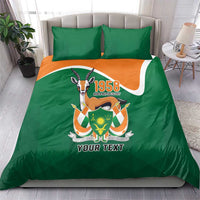 Green bedding set with orange stripe and 1958 emblem, plus matching pillow covers