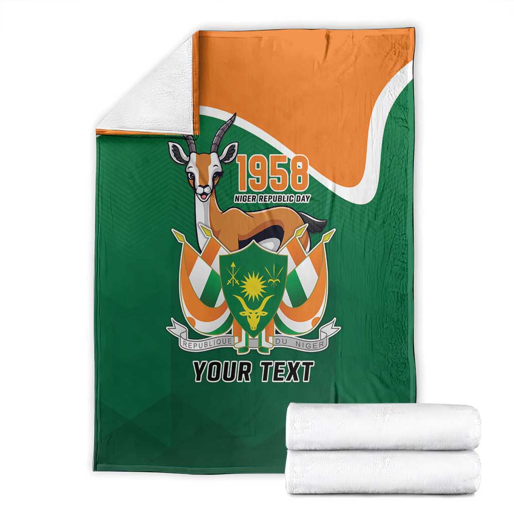 Personalized blanket with folded white towels, green with orange top, crest and 'YOUR TEXT'