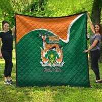 Green quilted throw quilt with orange top, '1958' crest and 'YOUR TEXT' displayed