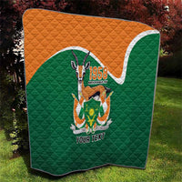 Green quilted throw quilt with orange top, emblem patch and 'YOUR TEXT' center