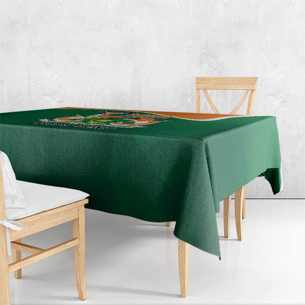Green tablecloth corner view with crest design and “YOUR TEXT” text
