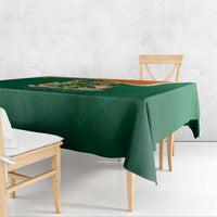 Green tablecloth corner view with crest design and “YOUR TEXT” text