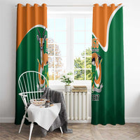 Green and orange window curtain panels with crest emblem and 'YOUR TEXT' on grommet header