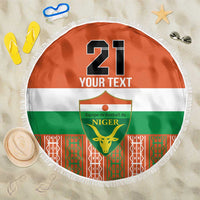 Orange round beach blanket with fringe, Niger emblem and “21 YOUR TEXT” print