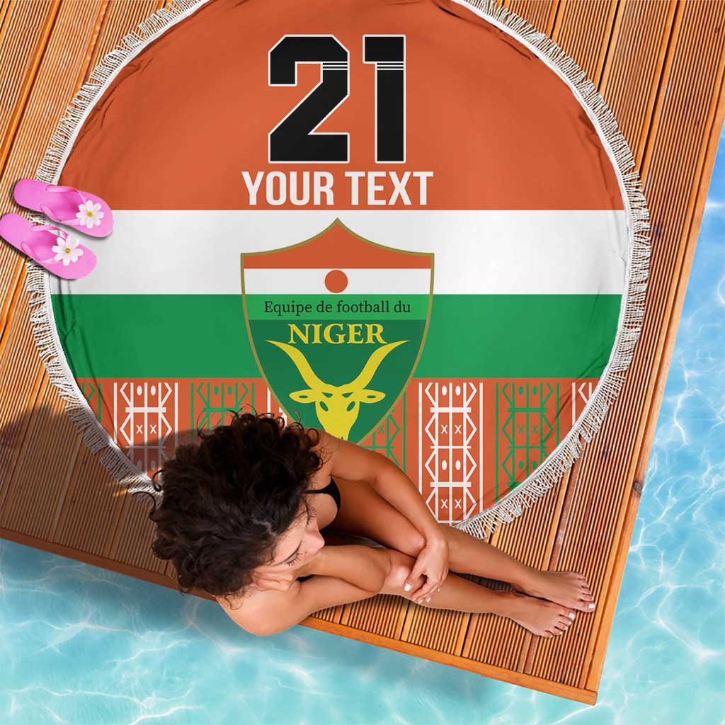 Orange round beach blanket with fringe, “21 YOUR TEXT” and Niger crest graphic