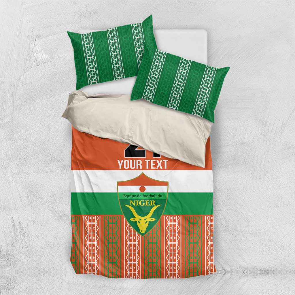 Custom bedding set laid flat with two green patterned pillowcases and orange/green duvet
