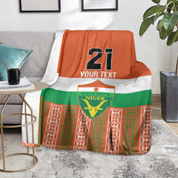 Orange football blanket with green and white geometric pattern, Niger crest and number 21