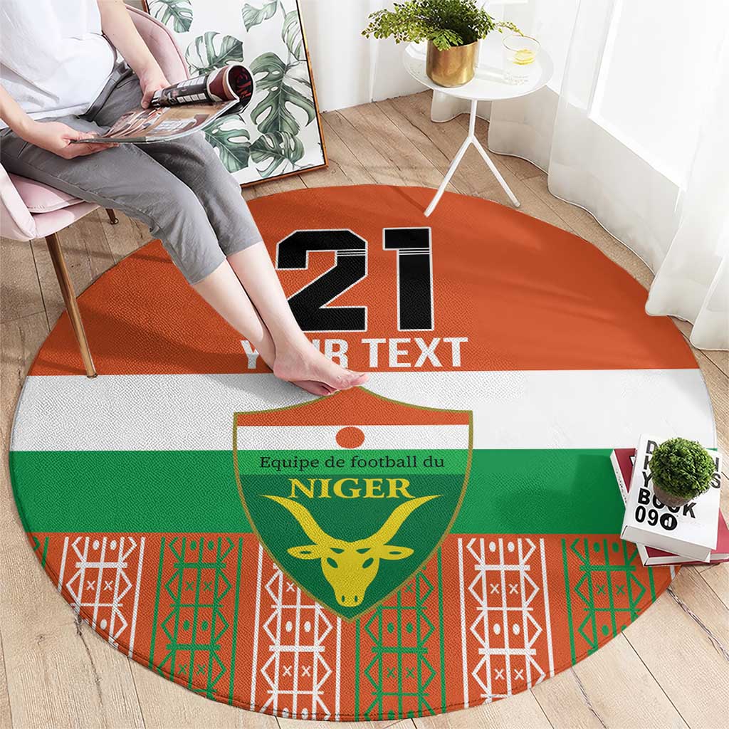 Orange round carpet with '21 YOUR TEXT' and central Niger crest, green red border