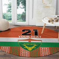 Orange round carpet with '21 YOUR TEXT' over Niger crest and colorful patterned edge