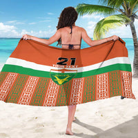 Orange custom sarong draped over shoulders with Niger flag crest, number 21 and text