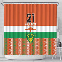 Orange shower curtain featuring large 21 graphic, Niger crest, and patterned border