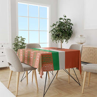 Orange custom tablecloth with green and white pattern on dining table