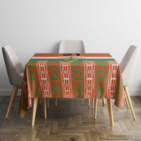 Orange tablecloth with green and white vertical motif pattern on dining table