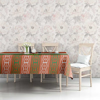 Orange tablecloth with green and white patterned edge on dining table