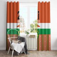 Custom window curtain panels on hooks, orange/white/green Niger design with number 21.