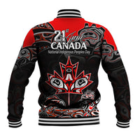 Back of red baseball jacket with black Indigenous art graphic and 21 June Canada text