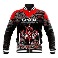 Red and black varsity baseball jacket with Indigenous art front graphic and striped ribbed collar