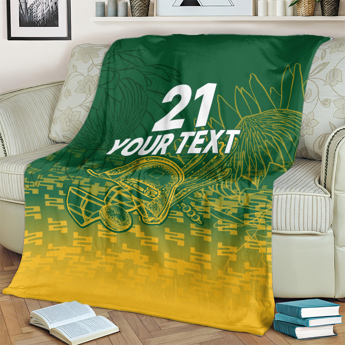 Custom cricket blanket on a bed; dark green upper half, gold lower half with “21 YOUR TEXT”.