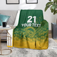 Custom cricket blanket on chair; dark green and gold design with “21 YOUR TEXT” and bat art.