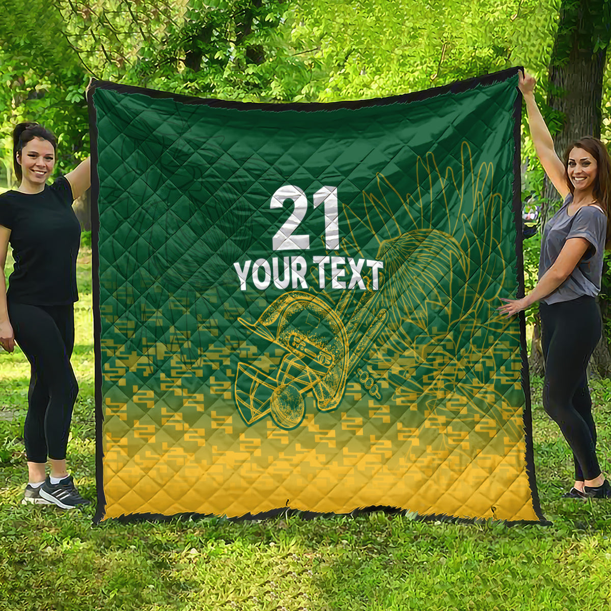 Green and yellow cricket quilt spread outdoors, with 21, 'YOUR TEXT', and trophy graphic