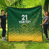 Green and yellow cricket quilt spread outdoors, with 21, 'YOUR TEXT', and trophy graphic